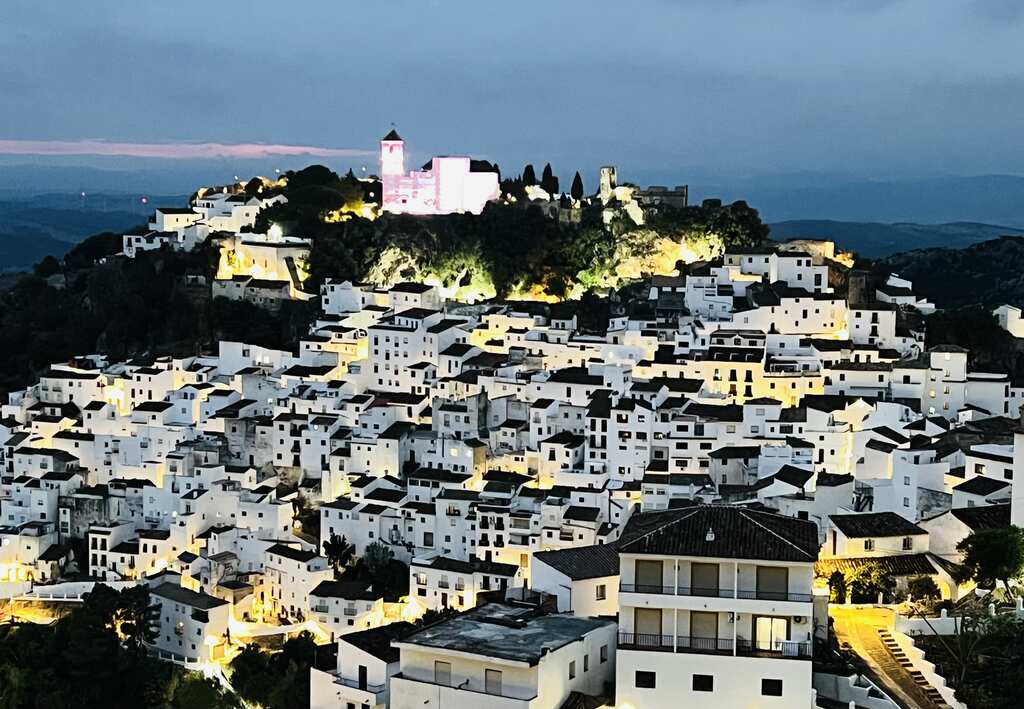 a white city with a castle on top of it